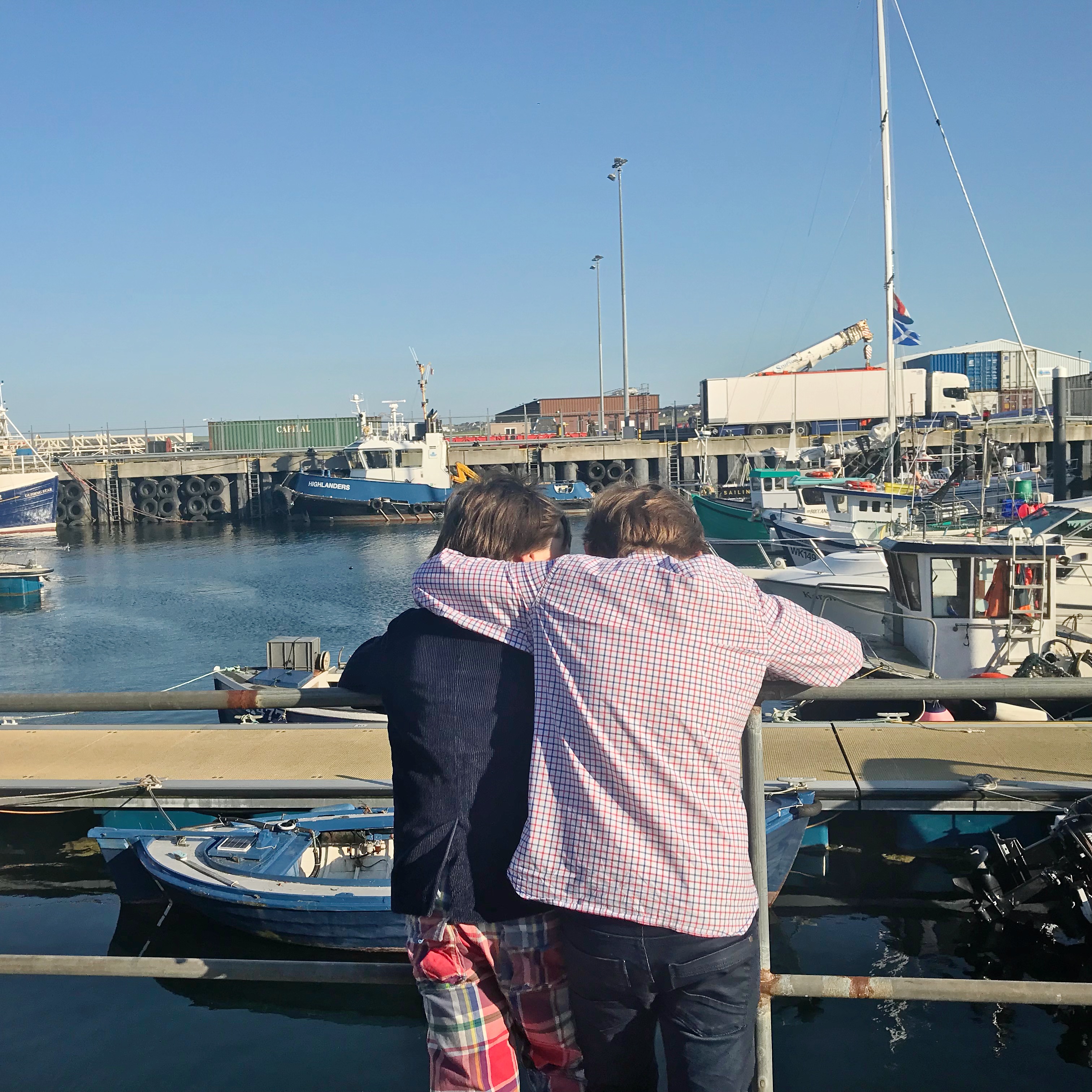 Two boys looking out over harbour view