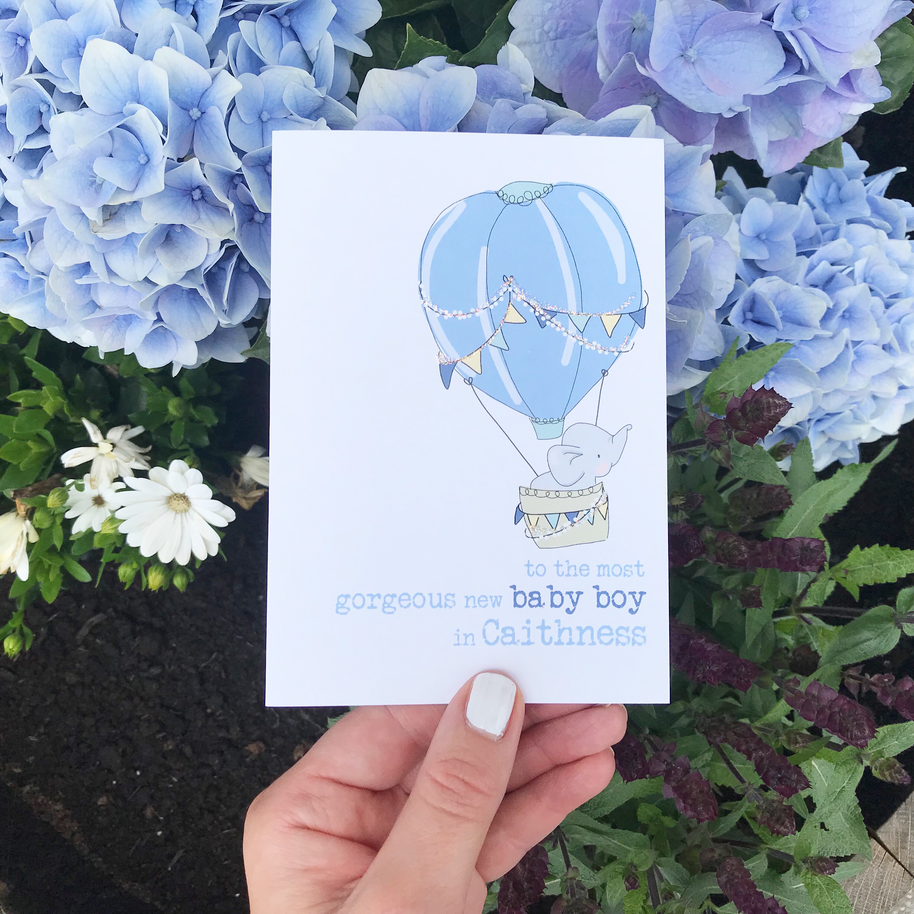 Photo of 'best new baby boy in Caithness' card against flowers