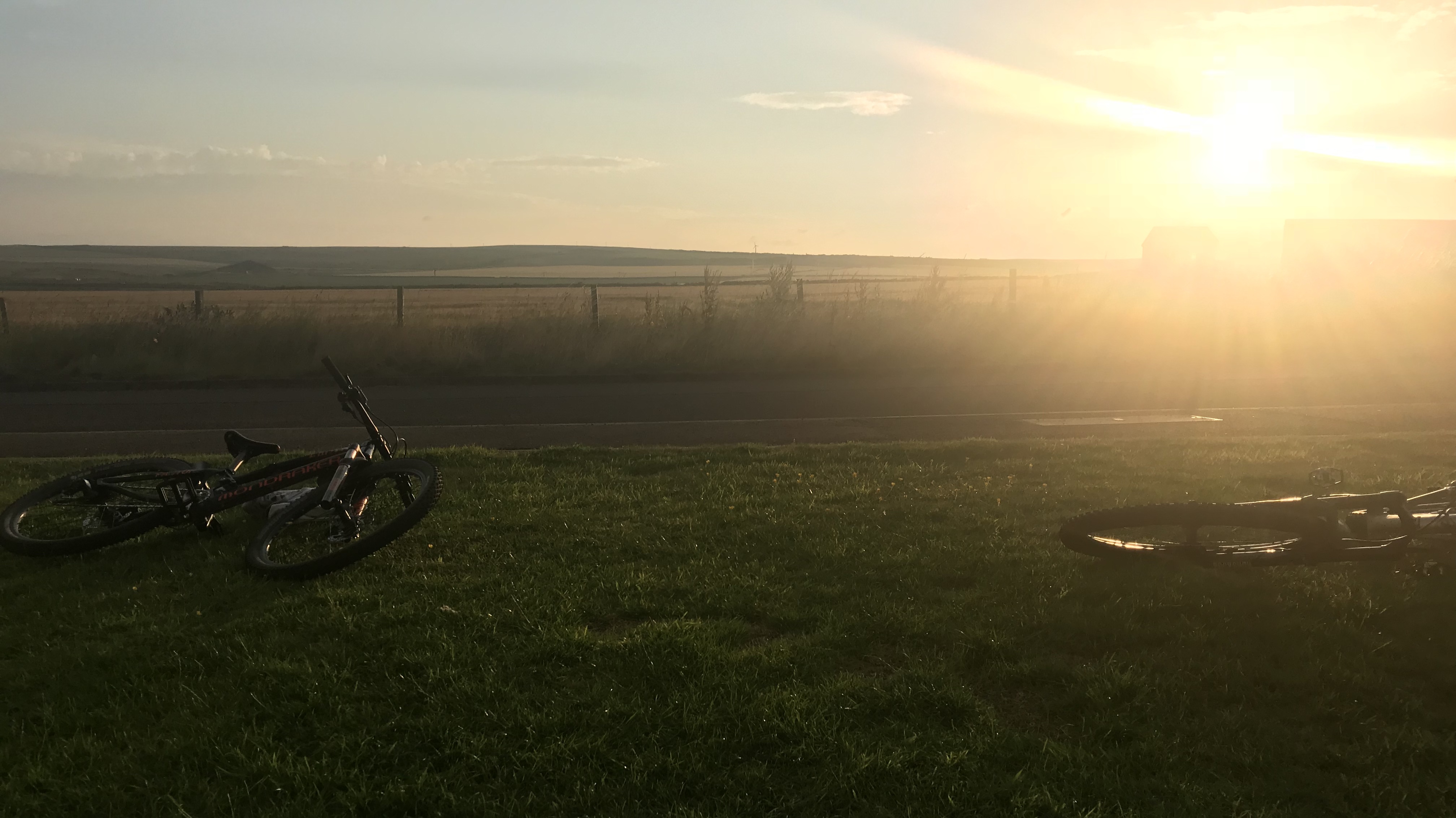 Picture of bikes laying outside against sunset