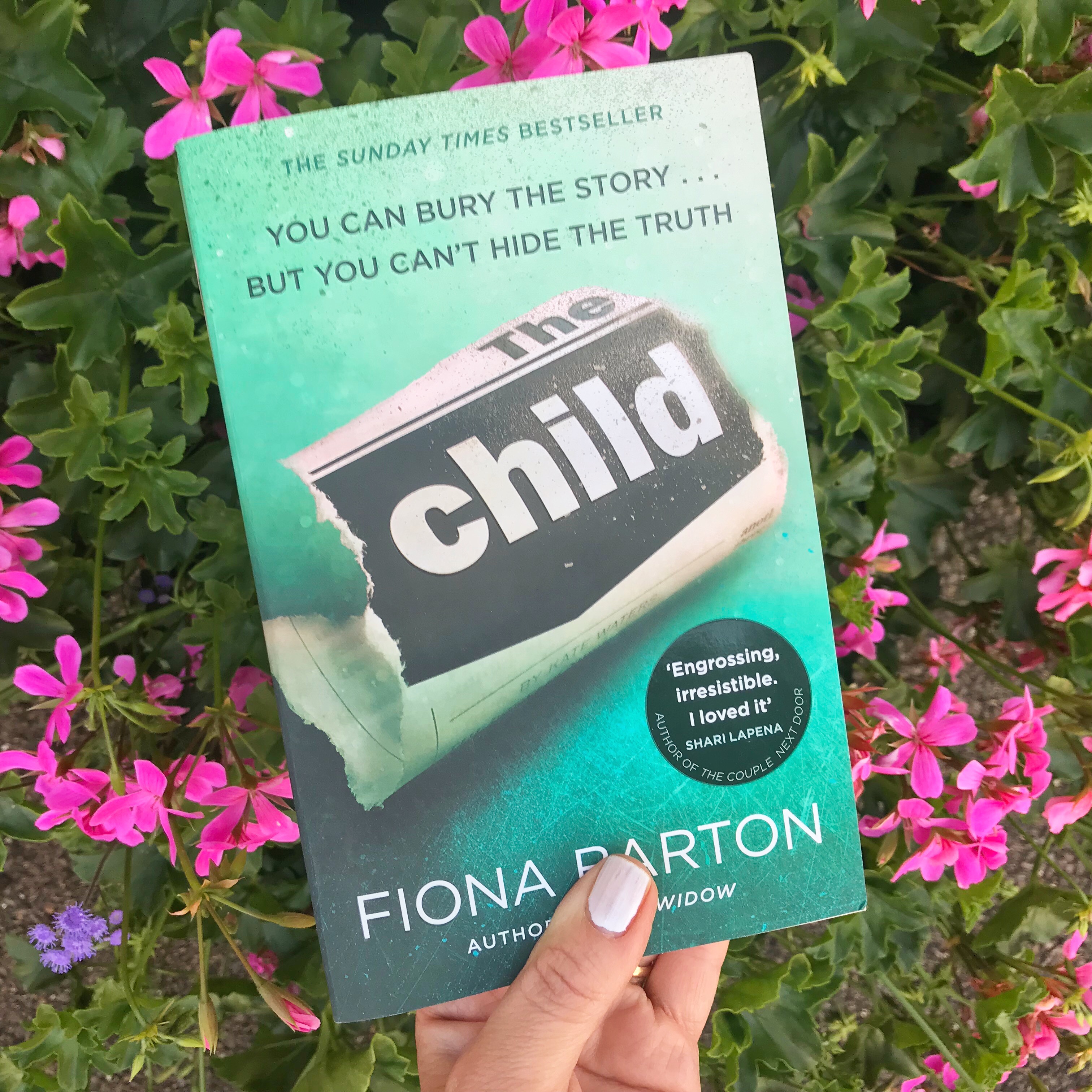 Picture of 'The Child' book against flowers