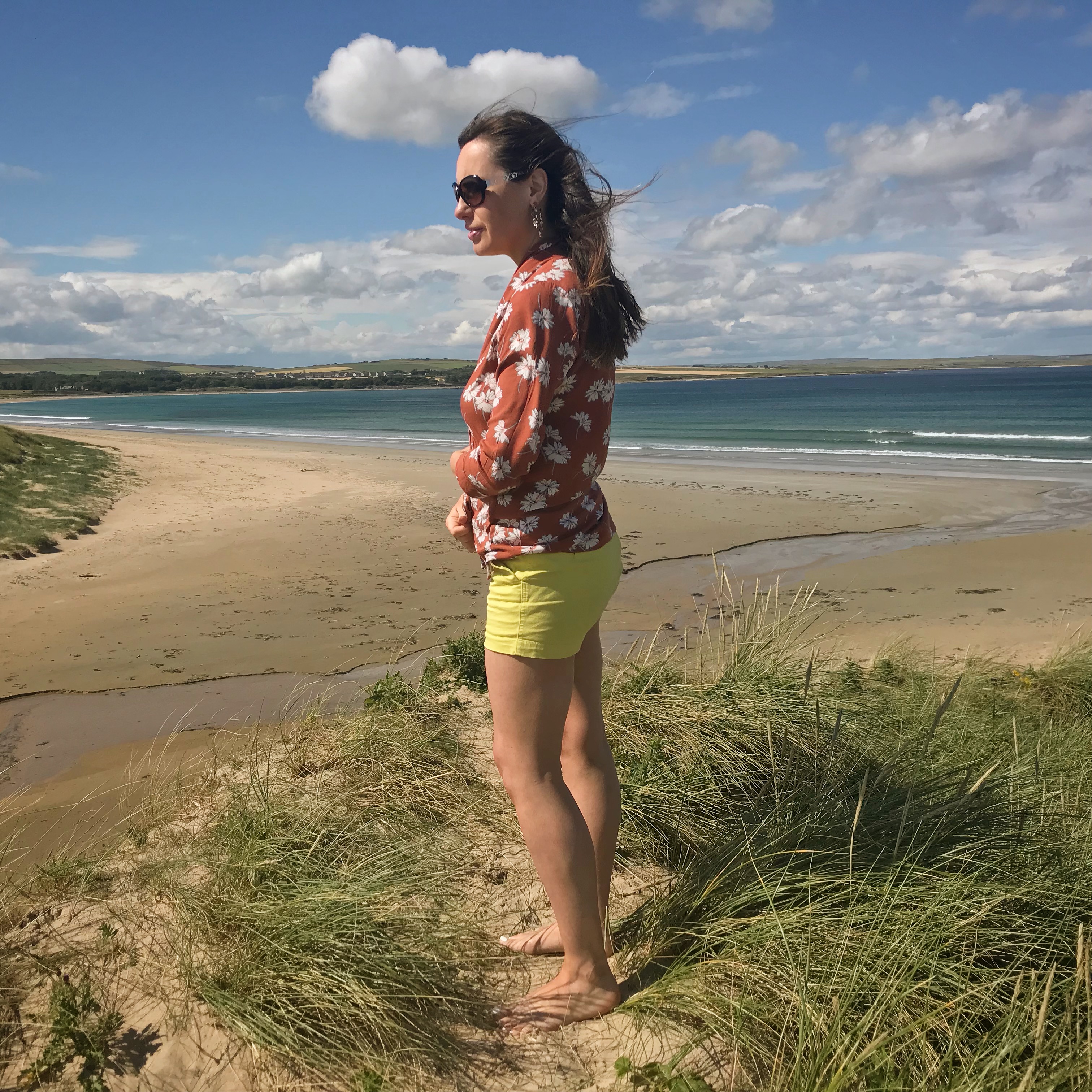 Gail on sand dune in Dunnet looking out over beach