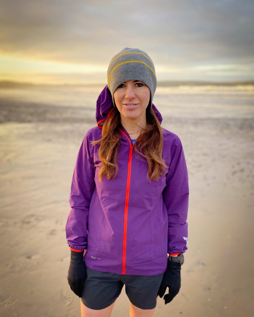 Photo of Gail in running gear at beach