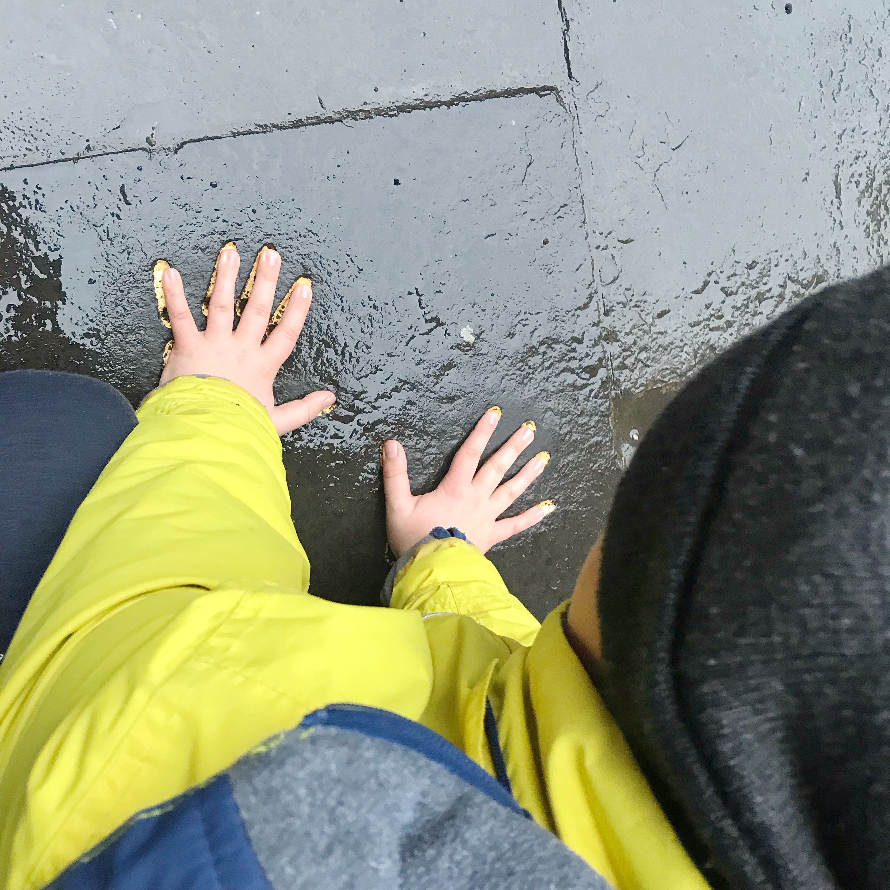 Trying out J.K. Rowling's Handprints for size, Edinburgh