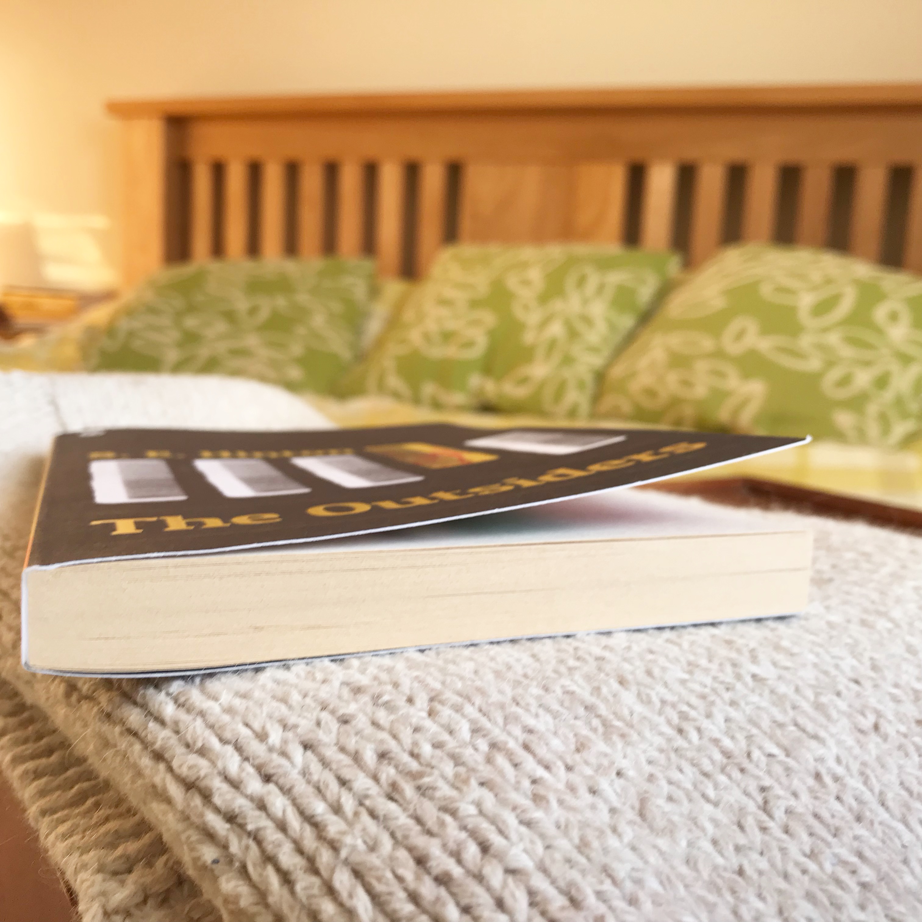 Picture of 'The Outsiders' book on bed