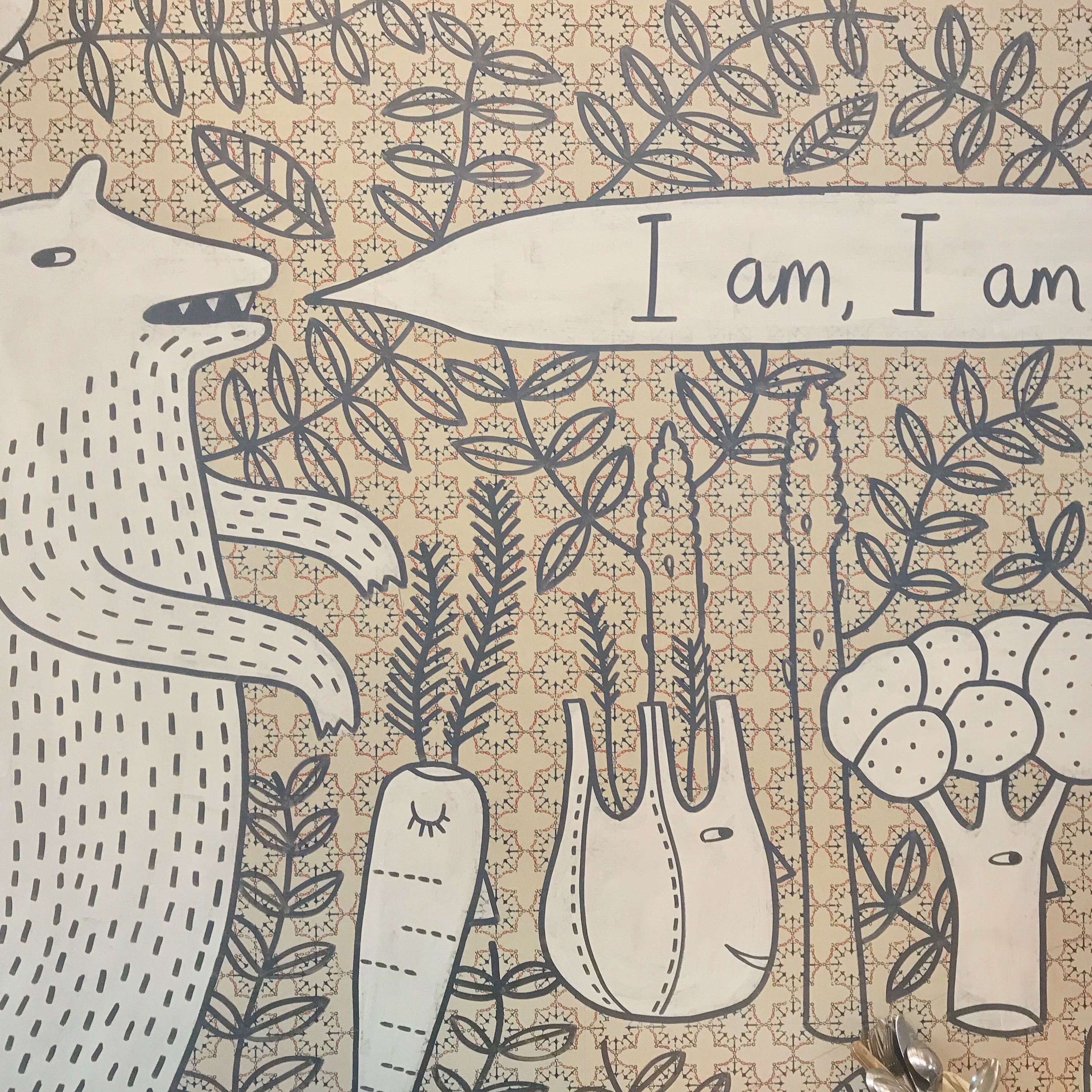 Wall art with bear saying (in speech bubble) 'I am, I am.'