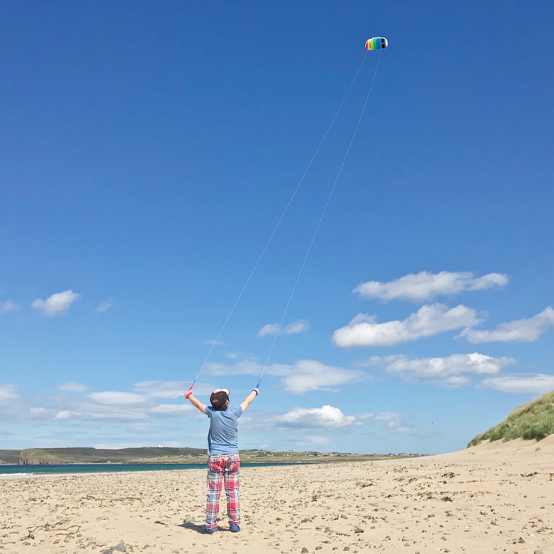 Picture of boy flying kite on beach