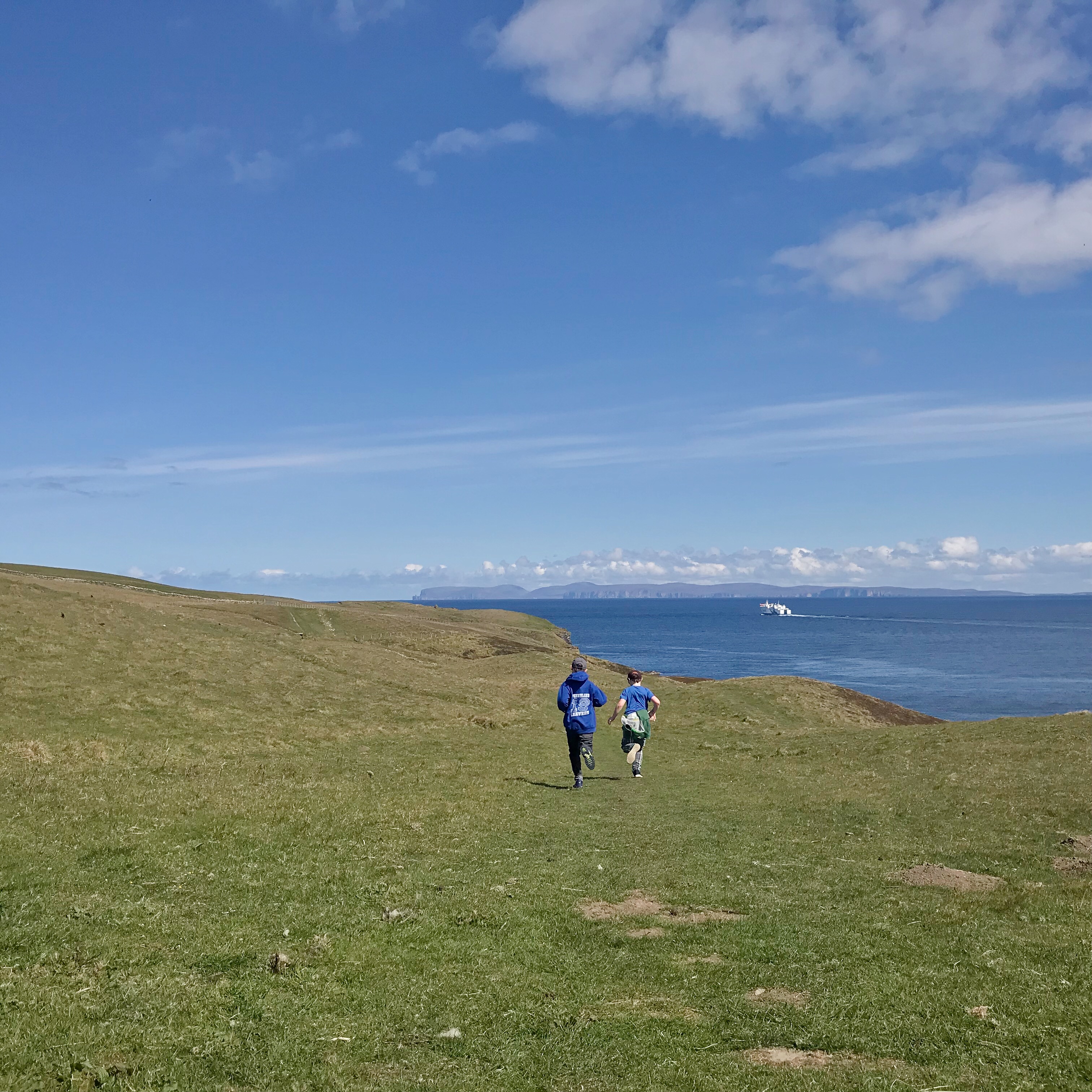 Kids running at Holbrn Head, Caithness