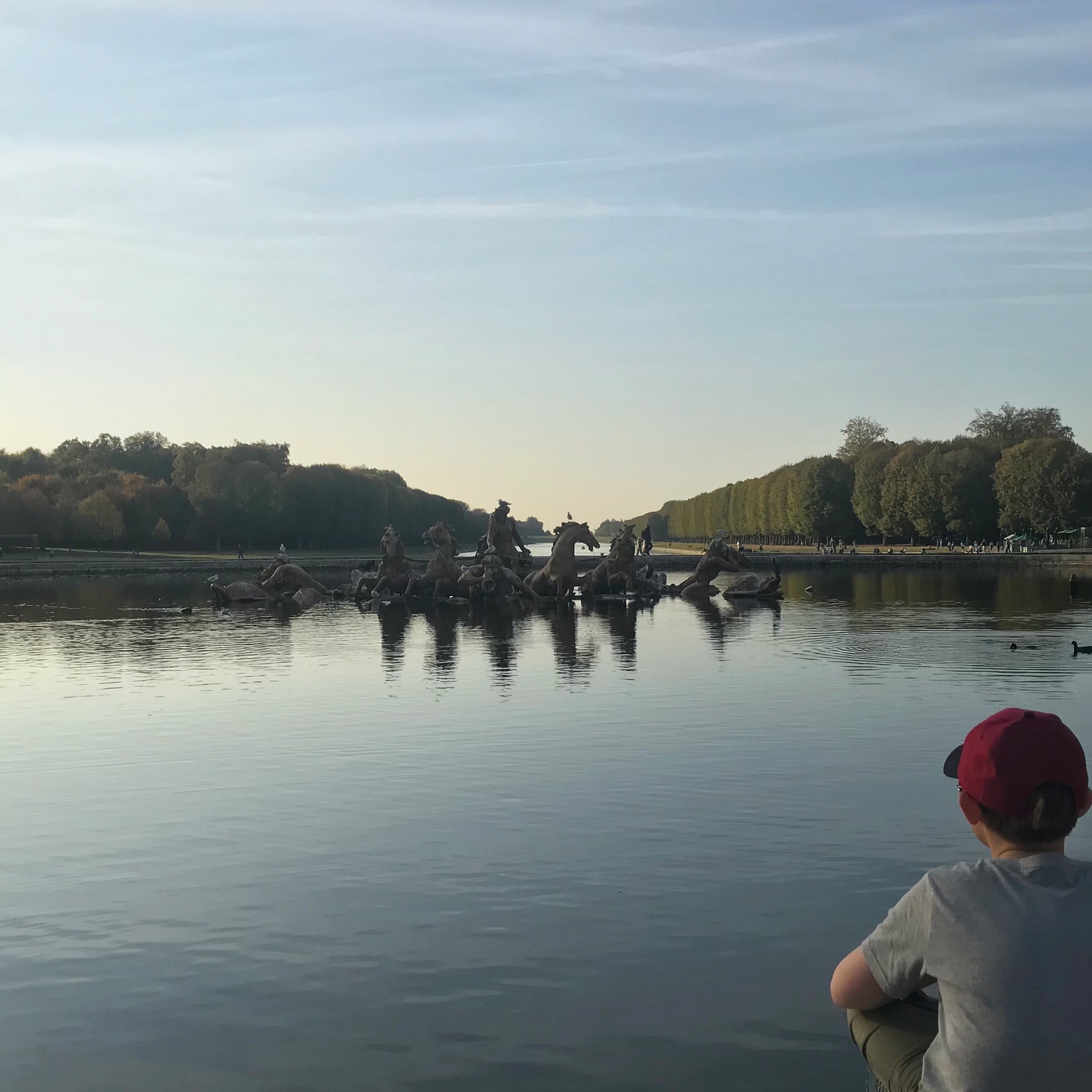 Boy looking out over Palace of Versailles Gardens