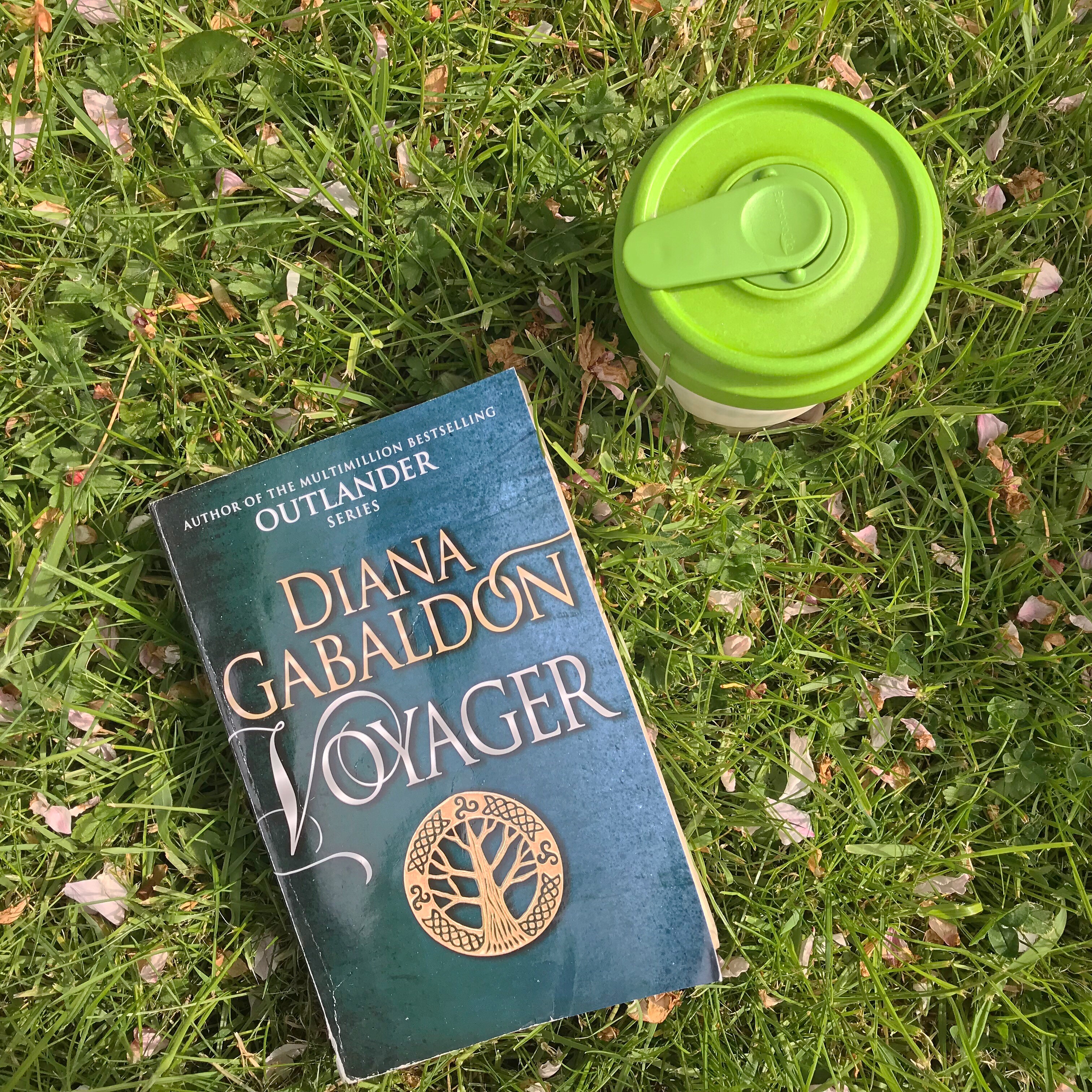 Voyager (Outlander 3) book on grass with coffee cup