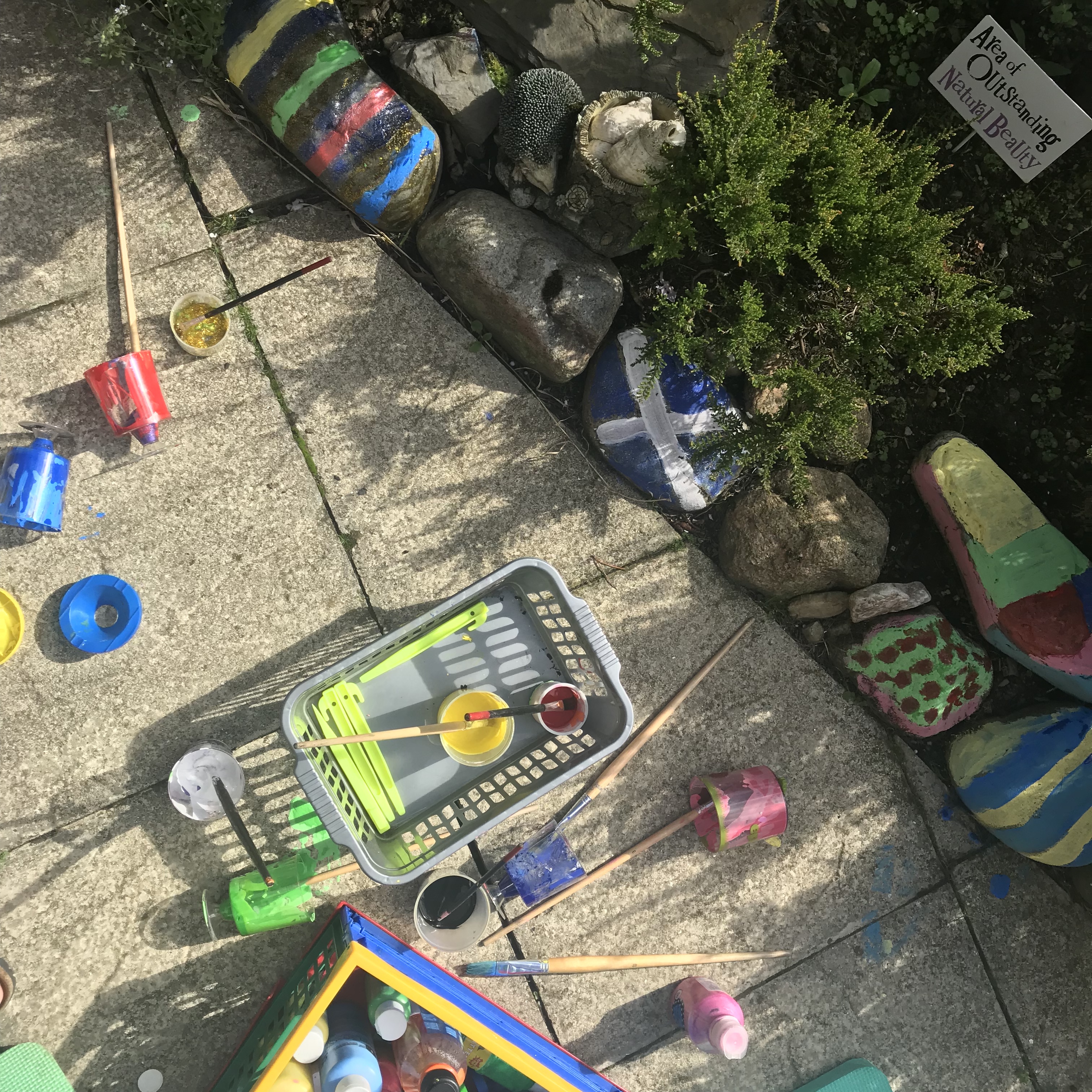 Picture from above of painted rocks on patio